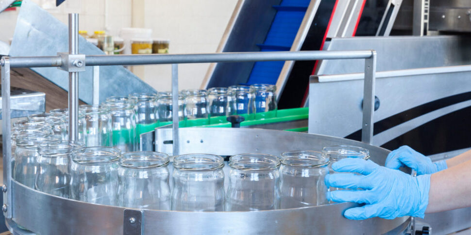 glass jars on the filling line in factory