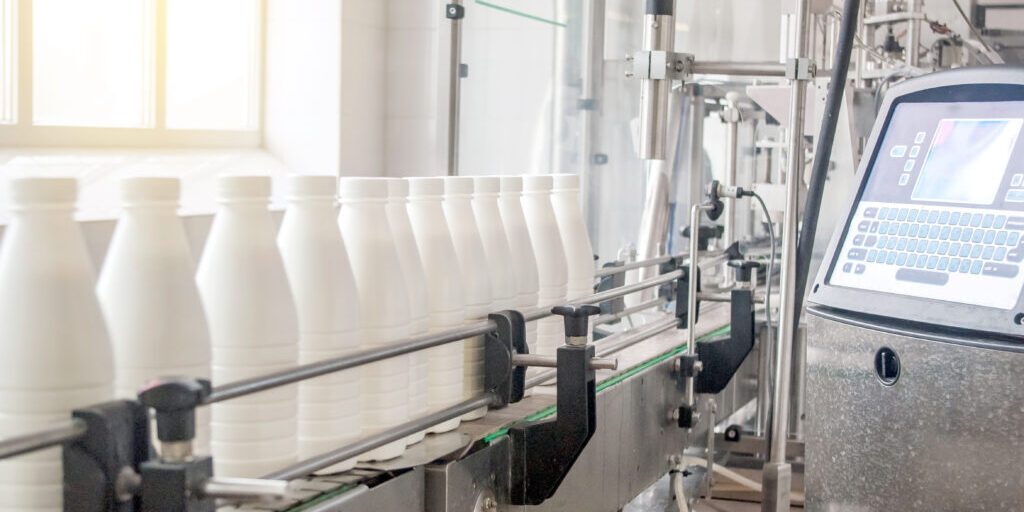 Conveyor belt with white milk bottles